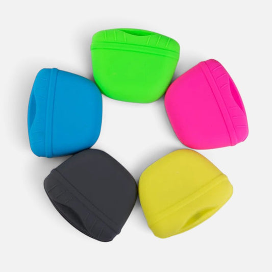 Tailora dog training treat pouches in green, pink, yellow, blue, and black arranged in a circle on a white background.