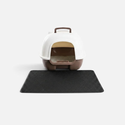 Tailora black double-layer honeycomb litter mat placed in front of a white and brown hooded cat litter box