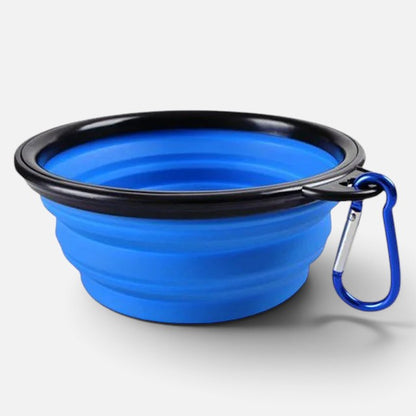 Tailora blue collapsible silicone pet travel bowl with a black rim and attached metal carabiner clip.