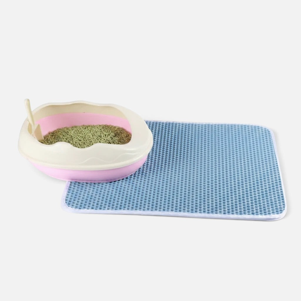 Tailora blue honeycomb double-layer cat litter mat next to a pink litter box on a white background