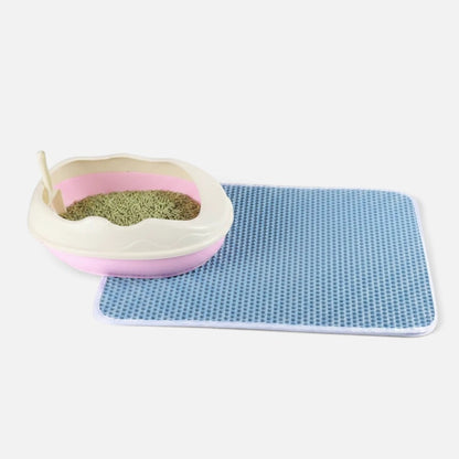 Tailora blue honeycomb double-layer cat litter mat next to a pink litter box on a white background