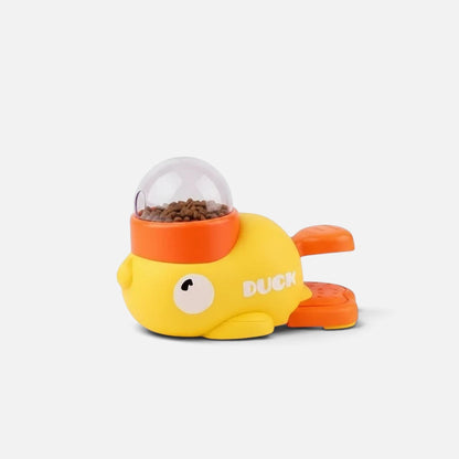 Tailora interactive duck-shaped treat dispenser toy in yellow and orange with a clear food container
