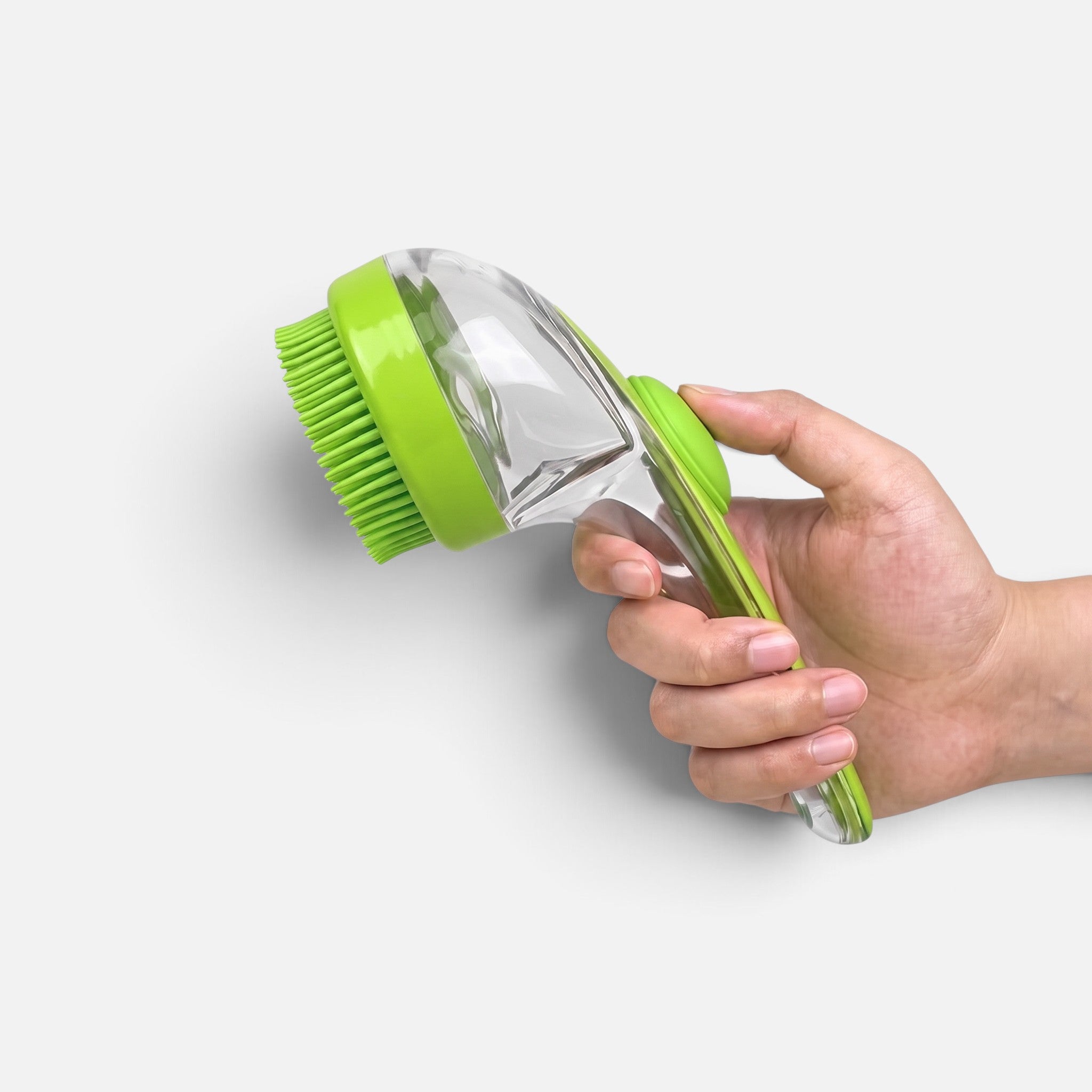 Tailora 2-in-1 pet bath brush with green silicone bristles and ergonomic clear handle held in a hand
