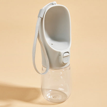 Tailora leak-proof portable dog water bottle with a grey drinking trough, lock button, and carrying lanyard.