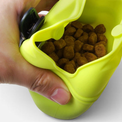 Tailora lime green silicone dog treat pouch being held open to show dry food inside for easy training access.
