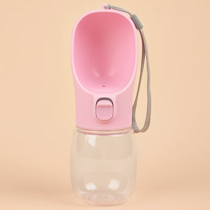Tailora pink portable leak-proof dog water bottle with a built-in drinking trough and carrying lanyard.