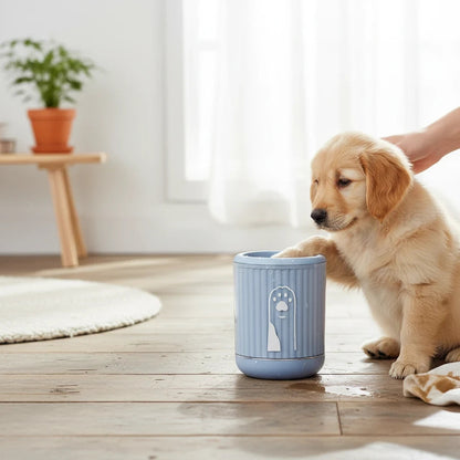 Tailora portable paw washer cup in light blue with soft silicone bristles being used by a golden retriever puppy