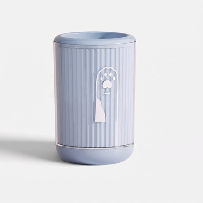 Tailora portable paw washer cup in light blue with a ribbed design and a cute paw print icon on the front