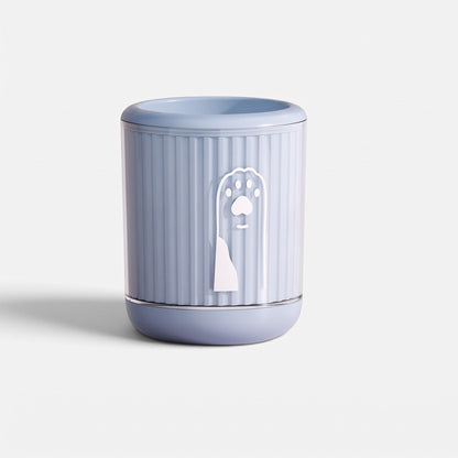 Tailora portable paw washer cup in light blue with a white paw print icon and soft silicone bristles inside