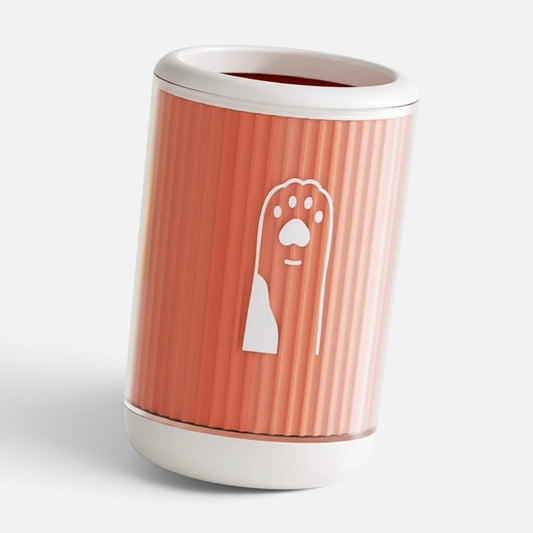 Tailora portable paw washer cup in coral orange with white trim and a cute paw print icon on the side