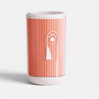 Tailora portable paw washer cup in coral pink with a white paw print logo and soft silicone interior bristles