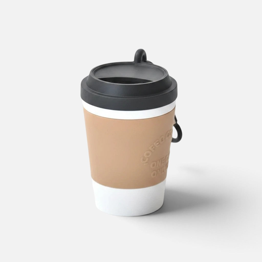 Tailora portable dog poop bag dispenser designed as a white and tan coffee cup with a secure odor-sealing lid.