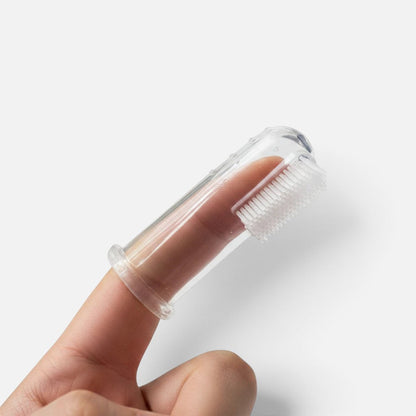 Tailora clear silicone finger toothbrush worn on a finger, featuring soft bristles for pet dental care.