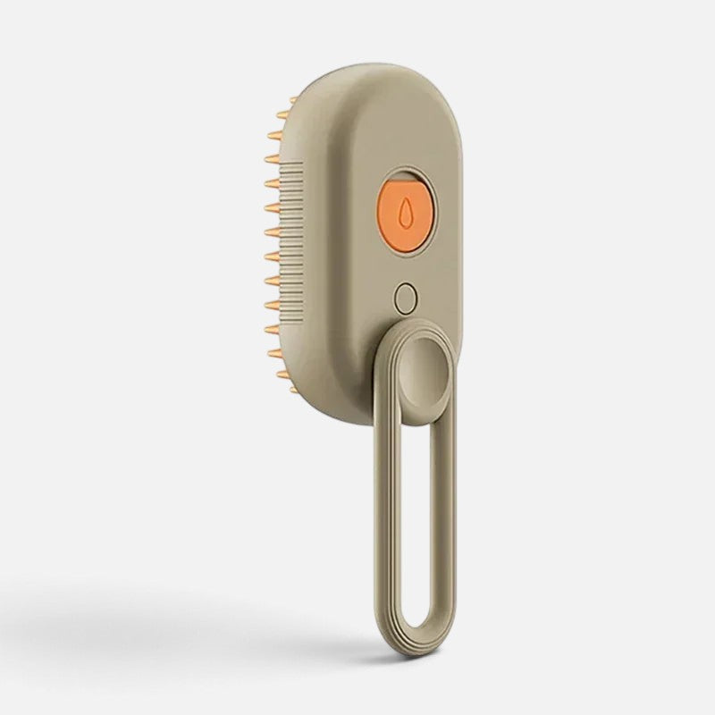 Tailora 3-in-1 steamy spray grooming brush in beige with orange button and soft silicone bristles for pet deshedding