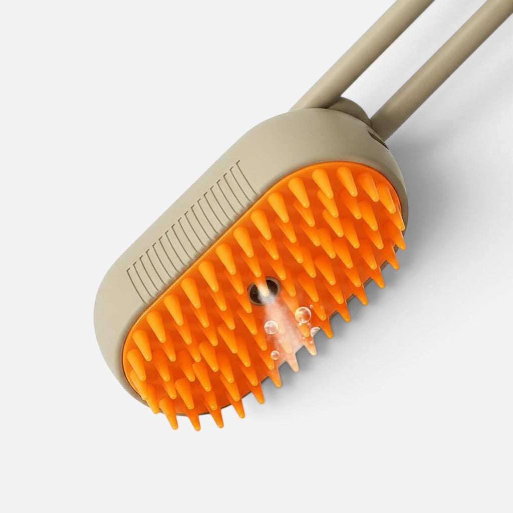 Tailora 3-in-1 steamy spray grooming brush with orange silicone bristles and a central nano-mist spray nozzle