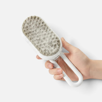 Tailora 3-in-1 steamy spray grooming brush with soft silicone bristles holding collected pet hair in a hand