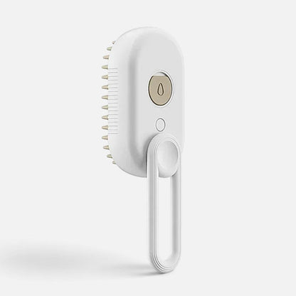 Tailora 3-in-1 steamy spray grooming brush in white with a gold button and hanging loop for pet deshedding